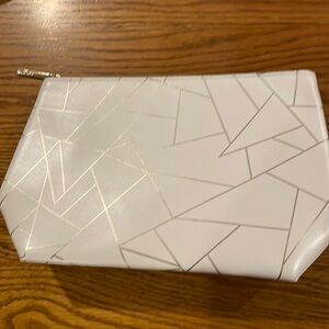 NWOT Lancôme cosmetic bag, white geometric design with gold trim, about 10X6”